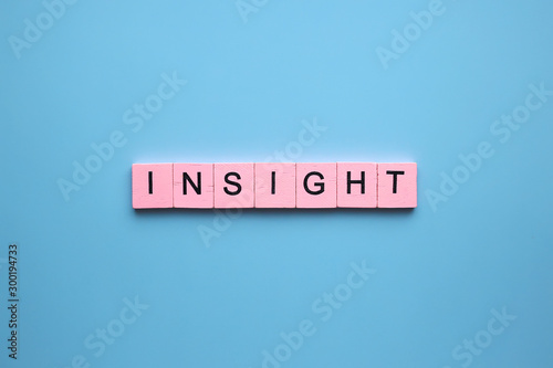 Insight word wooden cubes on blue background
