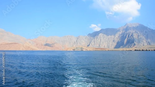 Blue waters of Musandam, Oman on a Dhow Boat trip in the Middle East the fjords, rocky mountains, and blue water near Strait of Hormuz 
