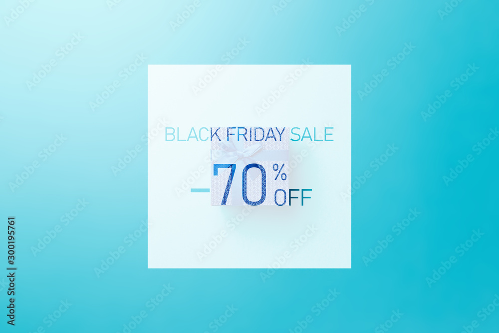 Black friday sale. Up to 70% discount. Text over Blue gift box with blue  ribbon