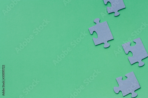 Puzzle pieces on green background. 