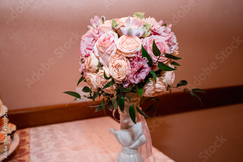 Wedding bridal bouquet on the table. Concept of marriage, family relationship, wedding paraphernalia.