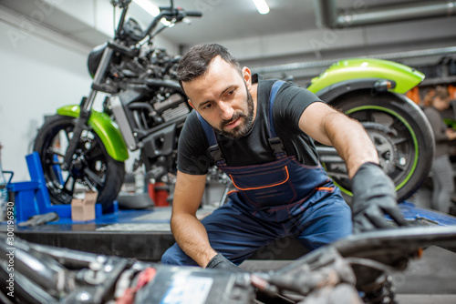 Biker with motorcycles in the garage