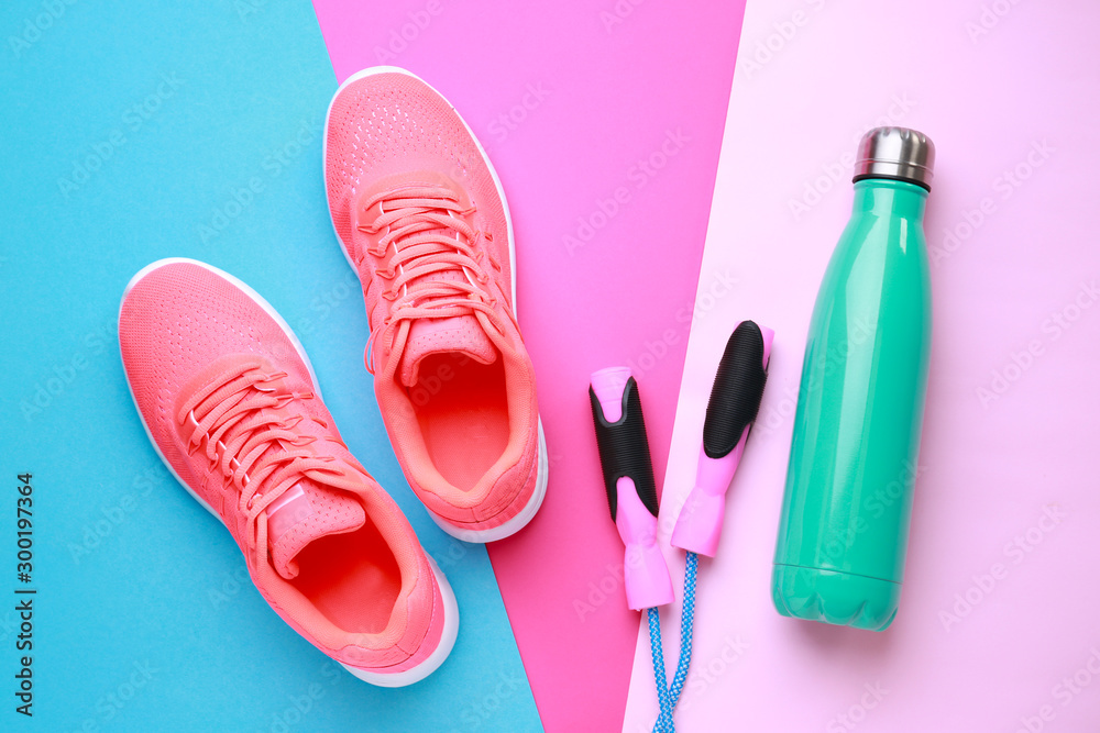 Sports water bottle, shoes and jumping rope on color background Stock Photo  | Adobe Stock