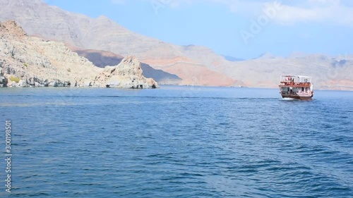 Blue waters of Musandam, Oman on a Dhow Boat trip in the Middle East the fjords, rocky mountains, and blue water near Strait of Hormuz 