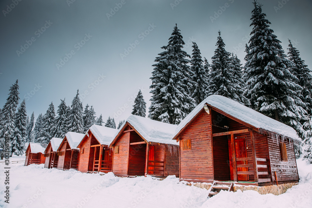 Abandoned wooden cottages up high in the mountains in winter
