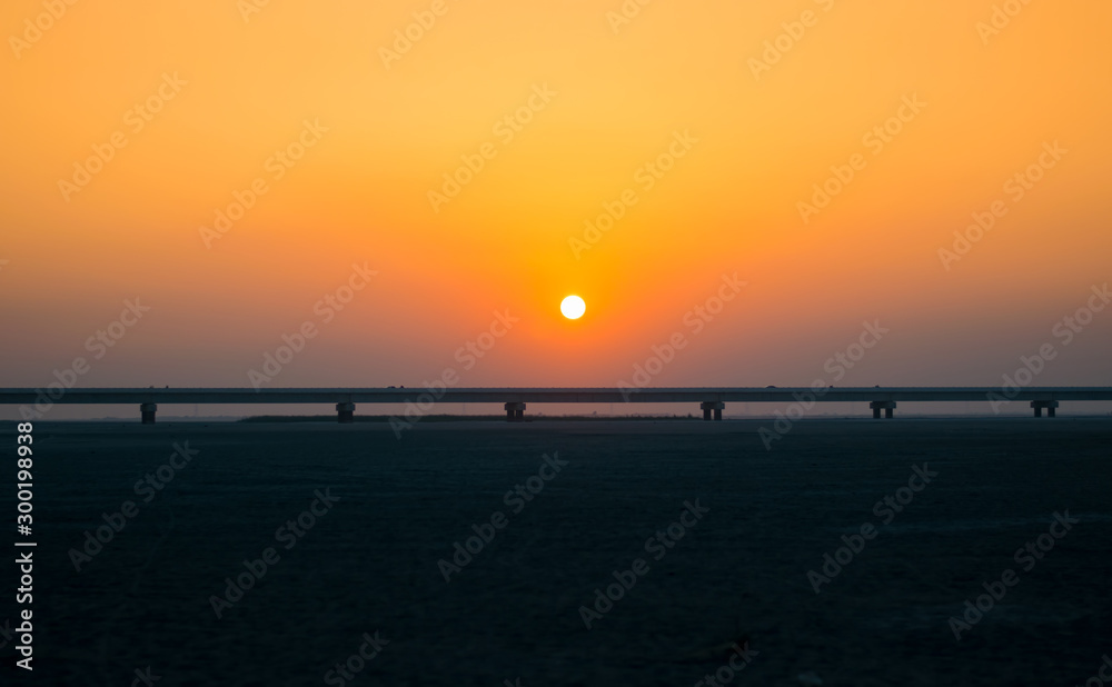 beautiful sunset on river bridge with orange background
