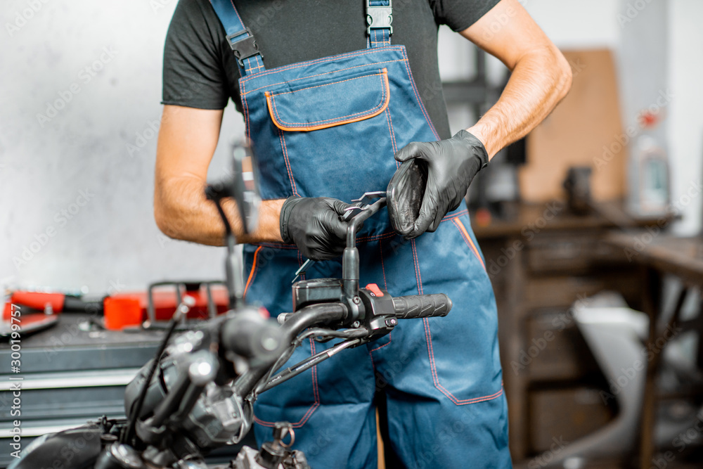 Mechanic repairing or tuning motorcycle Mechanic repairing or tuning motorcycle