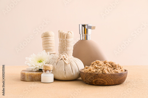 Cosmetics with herbal bags on light background