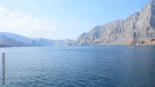 Blue waters of Musandam, Oman on a Dhow Boat trip in the Middle East the fjords, rocky mountains, and blue water near Strait of Hormuz 