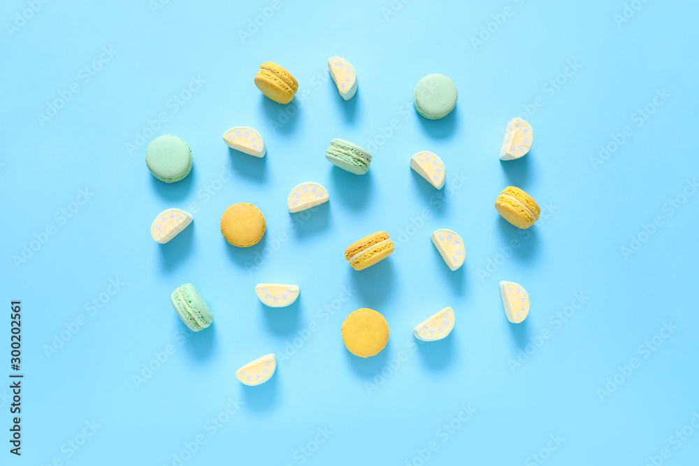 Tasty macarons with marshmallows on color background Tasty macarons with marshmallows on color background