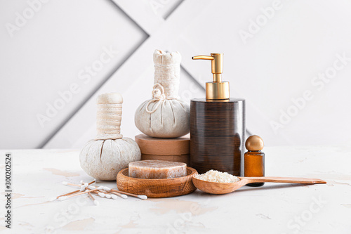 Cosmetics with herbal bags on white table