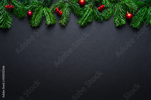 Black Christmas border with fir branches and baubles