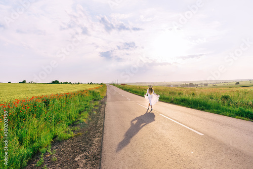 Wallpaper Mural back view of girl in dress and boater walks on the road near the Torontodigital.ca