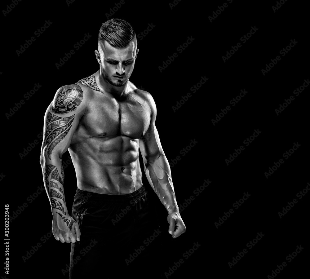 Handsome Muscular Men Posing and Flexing Muscles. Black and white image. copy space Handsome Muscular Men Posing and Flexing Muscles. Black and white image. copy space
