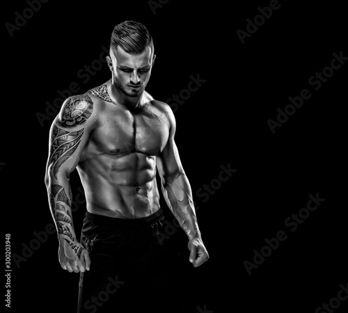 Handsome Muscular Men Posing and Flexing Muscles. Black and white image. copy space © mrbigphoto