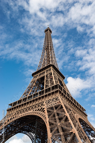 Paris Eiffel Tower frog view blue sky with clouds
