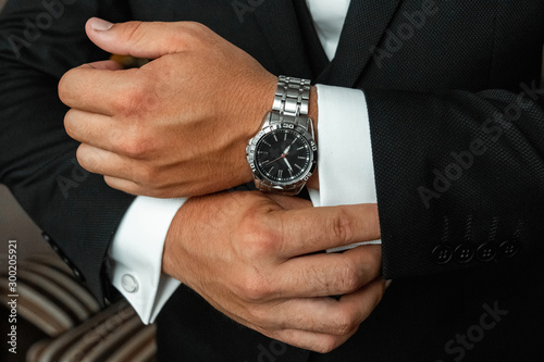 Hands of a businessman, close-up, buttons on a watch