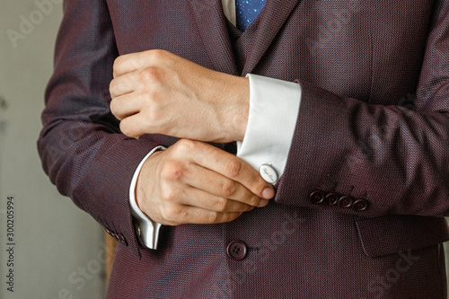 Hands of a businessman, closeup, button sleeves on a shirt.