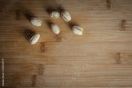 Pistachios nuts on the wood board top view