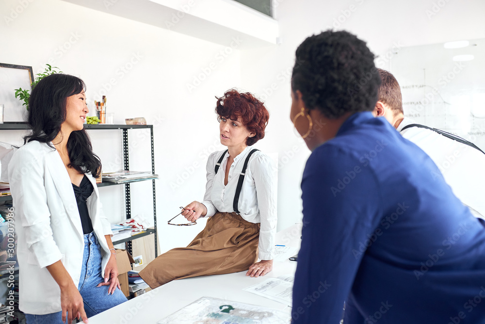 Group of multiethnic business people in formal suit standing near table, teamwork in modern workplace, people business group concept Group of multiethnic business people in formal suit standing near table, teamwork in modern workplace, people business group concept
