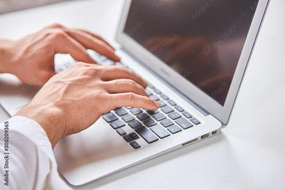 Selective focus of male's hands typing on laptop. Modern technologies, business Selective focus of male's hands typing on laptop. Modern technologies, business