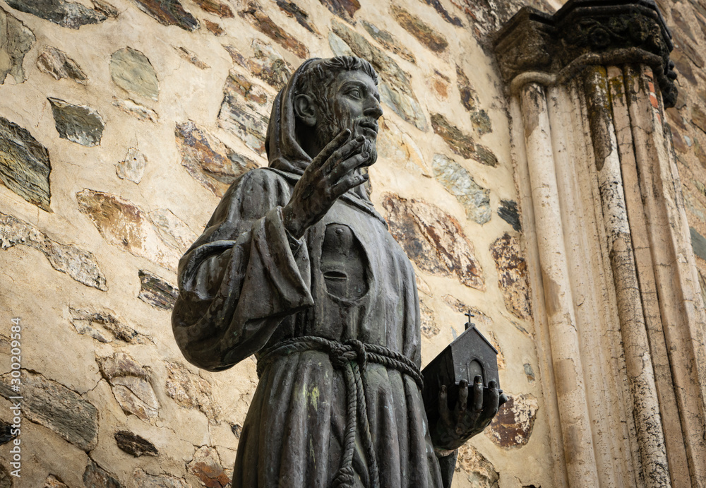 Statue of Saint Francis of Asissi at the gates of the Franciscan monastery of Guadalupe in Caceres, Spain.