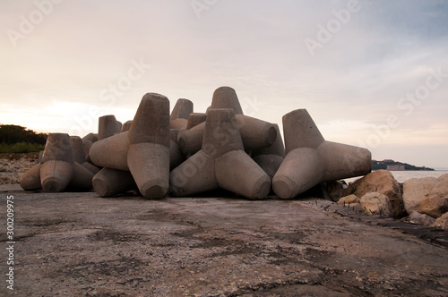 Tetrapod breakwaters. Tetrapod stones, close-up. Concrete tetrapods for protect coastal structures from sea waves. photo