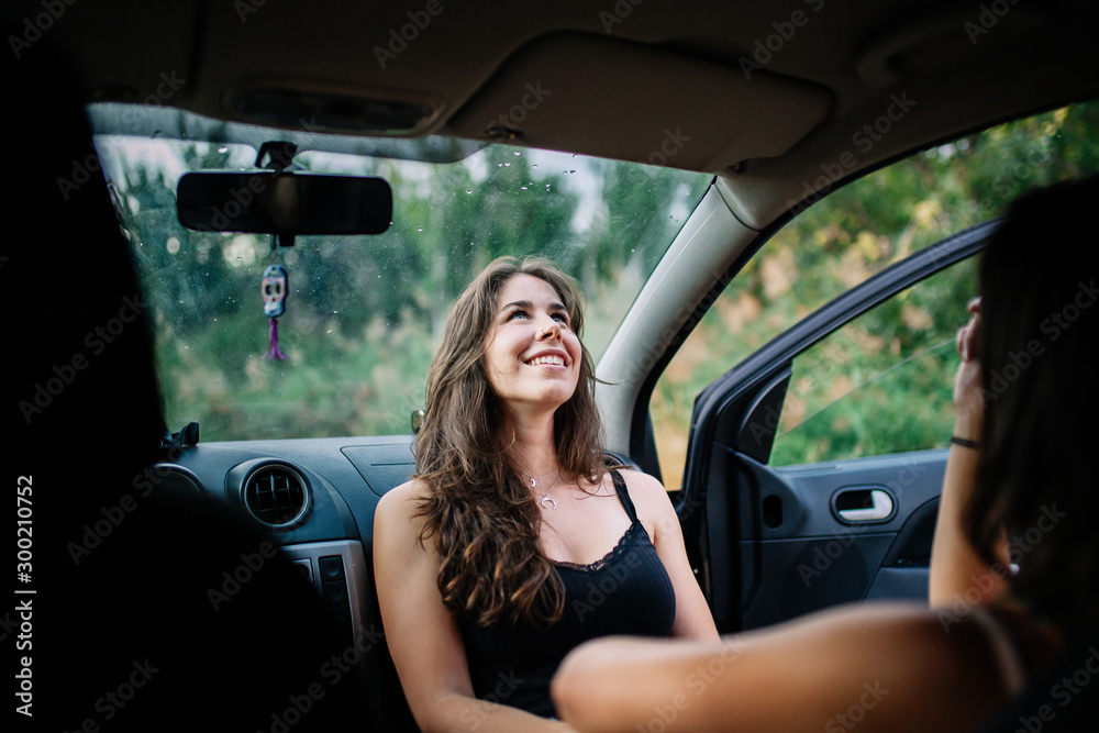 Two young lesbians enjoying inside a car