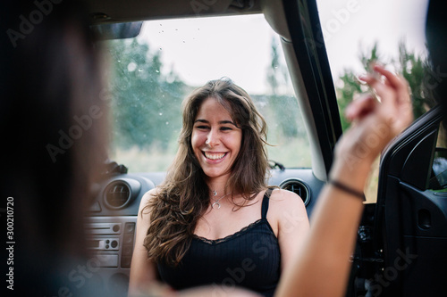Two young lesbians enjoying inside a car