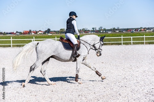 Horse riding . Young girl riding a horse . Equestrian sport in details. Sport horse and rider on gallop