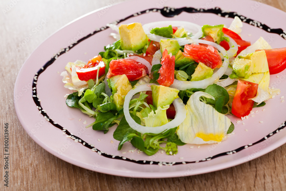 Tasty salad of  avocado, grapefruit, tomatoes  and corn salad