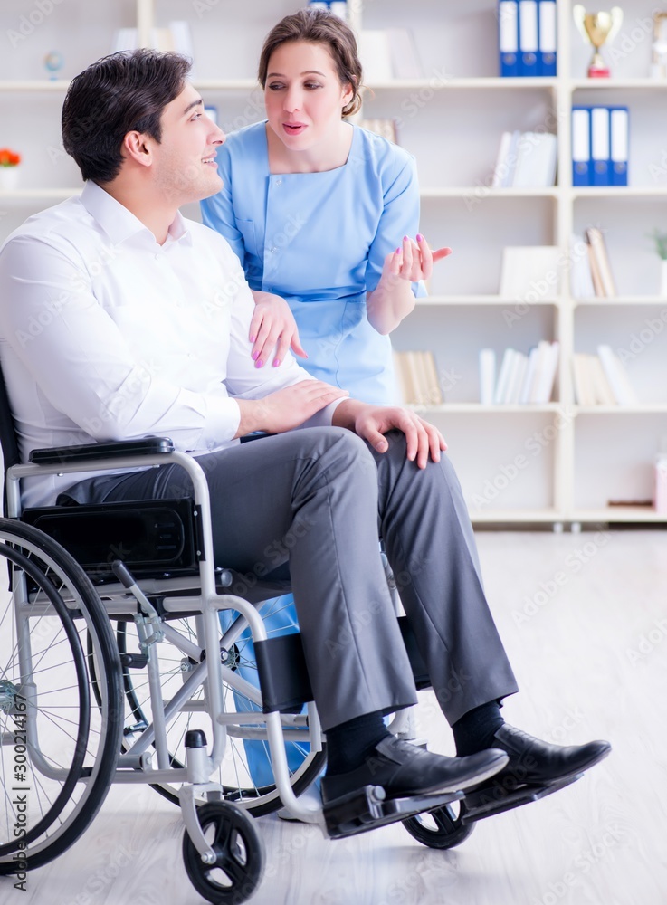 Disabled patient on wheelchair visiting doctor for regular check Disabled patient on wheelchair visiting doctor for regular check