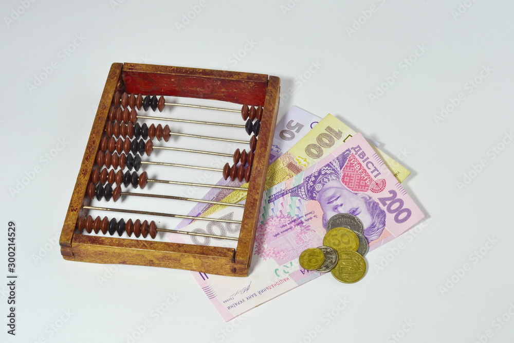 wooden old abacus and money isolated on a grey background wooden old abacus and money isolated on a grey background