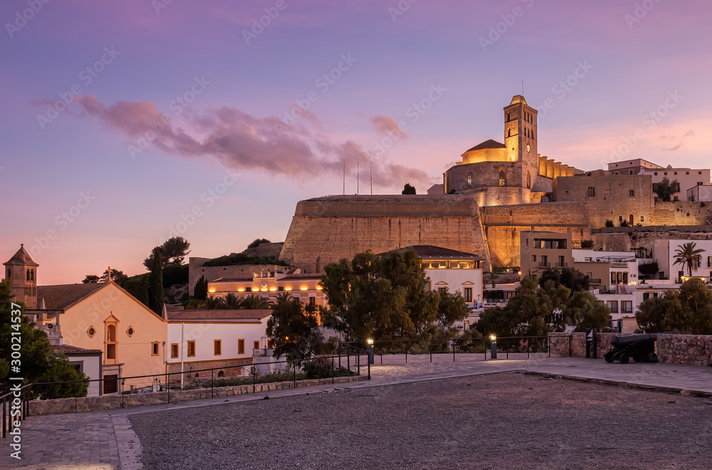 Beautiful sunset from the viewpoint of the historic area of ​​Dalt Vila in Ibiza, Baleares, Spain. Cathedral and white houses in the wall area