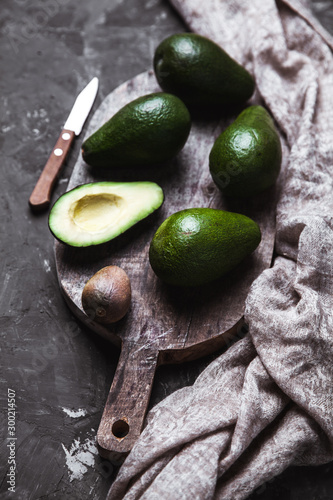 avocado on a cutting board with a kitchen towel in a vintage style photo