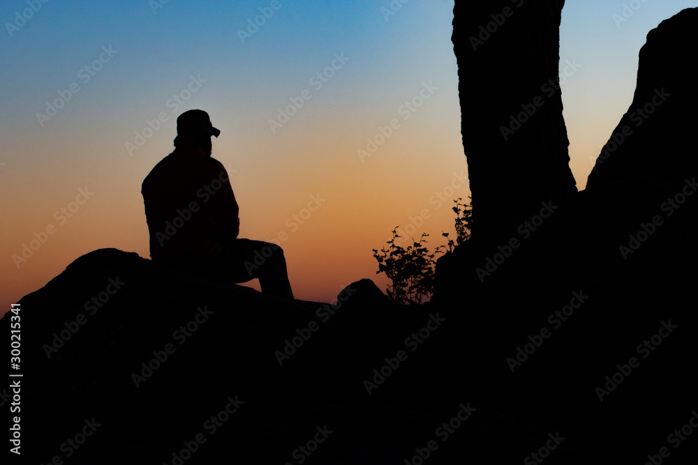 silhouette of man on background of sunset