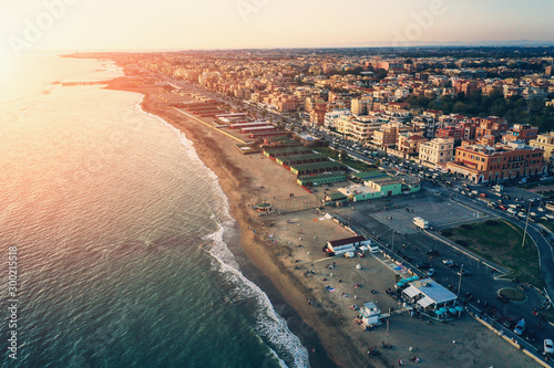 Ostia beach aerial view from drone. Ostia Lido near Rome, Italy. Beautiful sea, coast and city view at sunset from above.