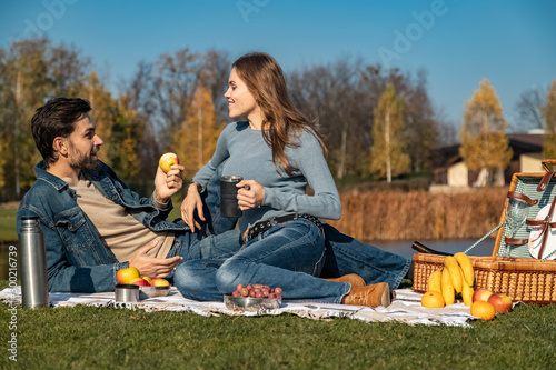 Young loving couple having a picnic outdoors
