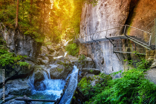 Majestic Waterfall near hiking trail in Bavarian alps. Travel nature destinations concept photo