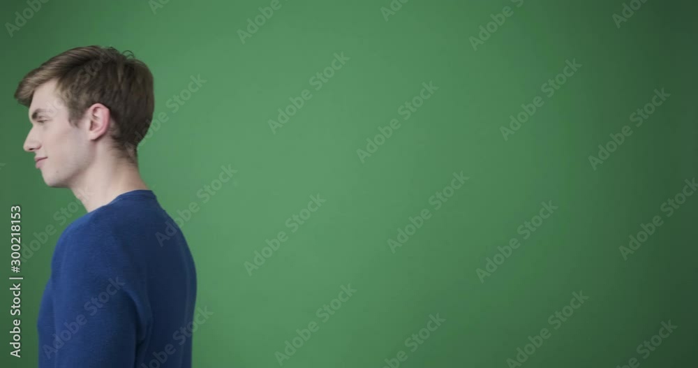 Happy young man inviting to come over green background Happy young man inviting to come over green background