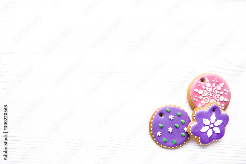 Icing gingerbread cookies on white wooden table, copy-space, space for text. Traditional Christmas homemade baking. Icing gingerbread cookies on white wooden table, copy-space, space for text. Traditional Christmas homemade baking.