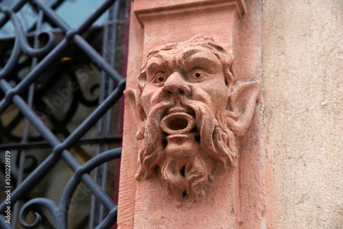 Gargoyle on the facade of a house in Alsace