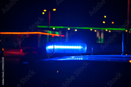 night time. blue police car with selective focus and blur bokeh.