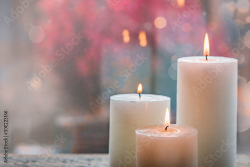 White burning candles with bokeh.