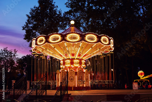 Carousel Merry go round in amusement park at evening city