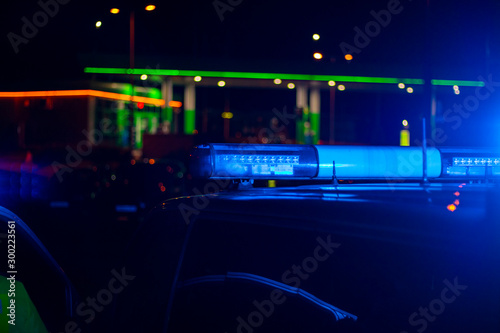 night time. blue police car with selective focus and blur bokeh.