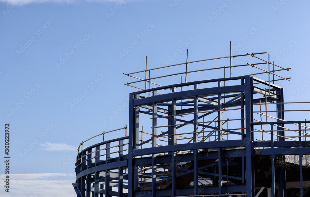 Building site girders and scaffolding against a blue sky Building site girders and scaffolding against a blue sky