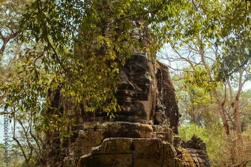 Stone statues of faces in Cambodian Angkor Wat Temple near Siem Reap city in Asia