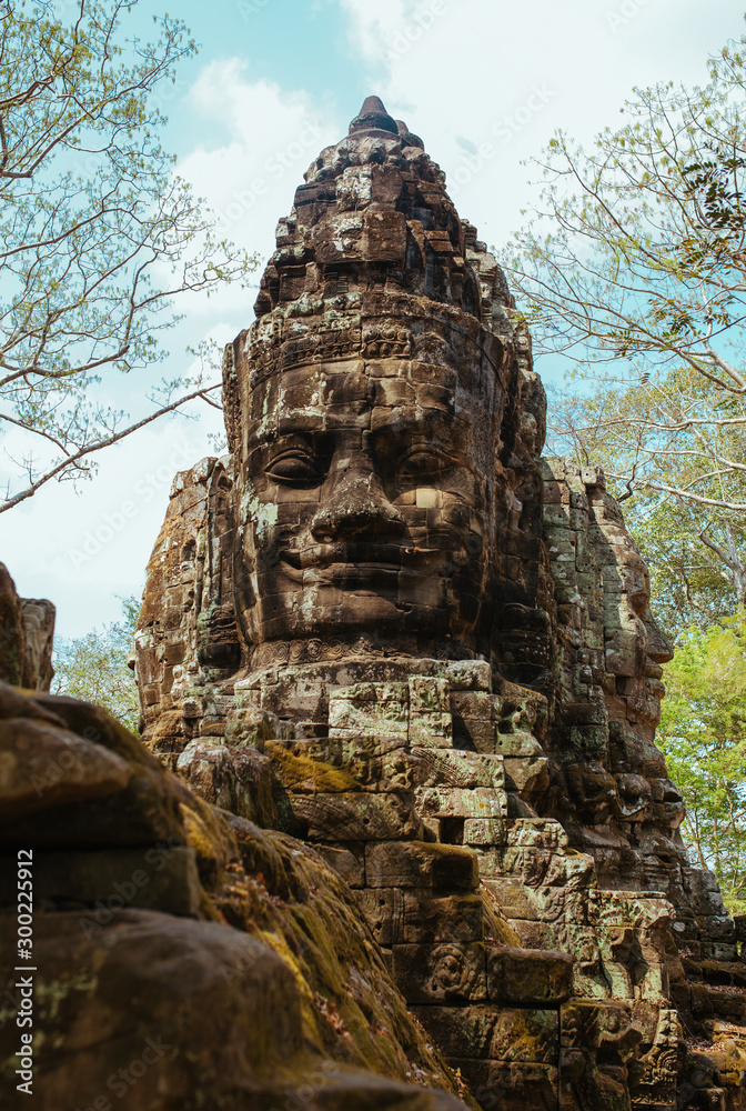 Stone statues of faces in Cambodian Angkor Wat Temple near Siem Reap city in Asia