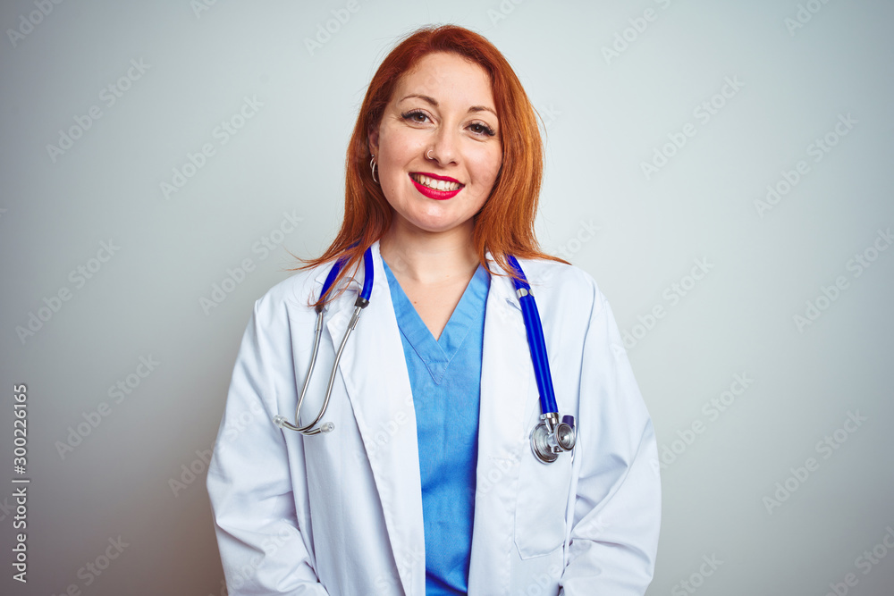 Young redhead doctor woman using stethoscope over white isolated background with hands together and crossed fingers smiling relaxed and cheerful. Success and optimistic Young redhead doctor woman using stethoscope over white isolated background with hands together and crossed fingers smiling relaxed and cheerful. Success and optimistic